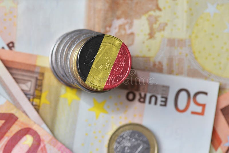 Euro coin with national flag of belgium on the euro money banknotes background