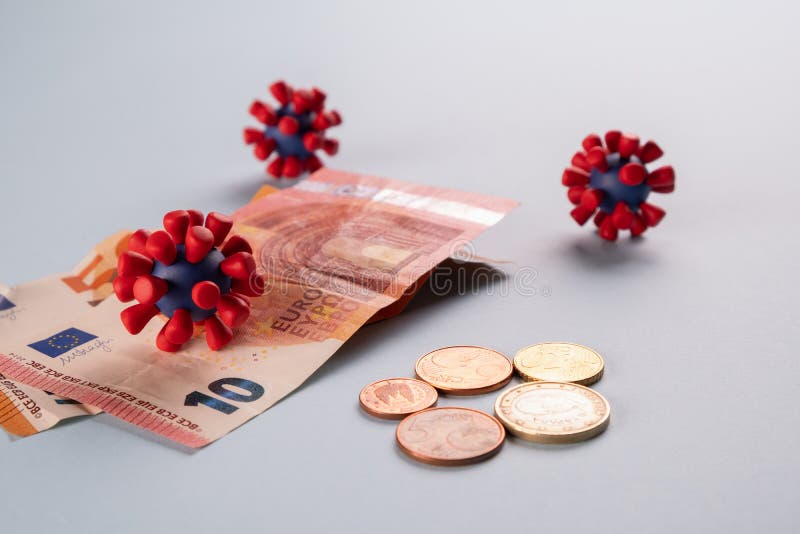 Euro money, coins and models of covid-19 virus on blue background.Contaminated infected cash money. Economy crisis. Euro money, coins and models of covid-19 royalty free stock image Euro money, coins and models of covid-19 virus on blue background.Contaminated infected cash money. Economy crisis. Euro money, coins and models of covid-19 royalty free stock image