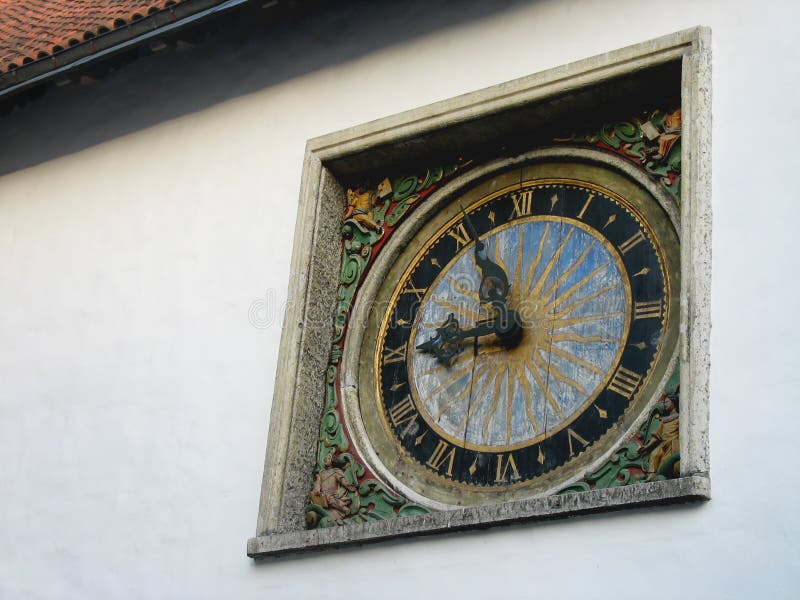 Europe. the Wall with Old Clock. the Sun and the Sky are on the Clock