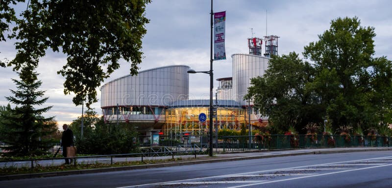 European Court of Human RIghts building in Strasbourg with silhouette of senior