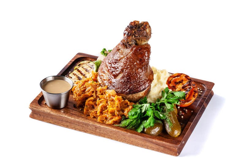 European, Czech cuisine. Pork knuckle on a wooden board with mashed potatoes, stewed cabbage, grilled vegetables and suck royalty free stock photo European, Czech cuisine. Pork knuckle on a wooden board with mashed potatoes, stewed cabbage, grilled vegetables and suck royalty free stock photo