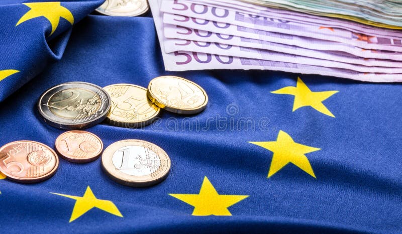 European flag and euro money. Coins and banknotes European currency freely laid on the Eur