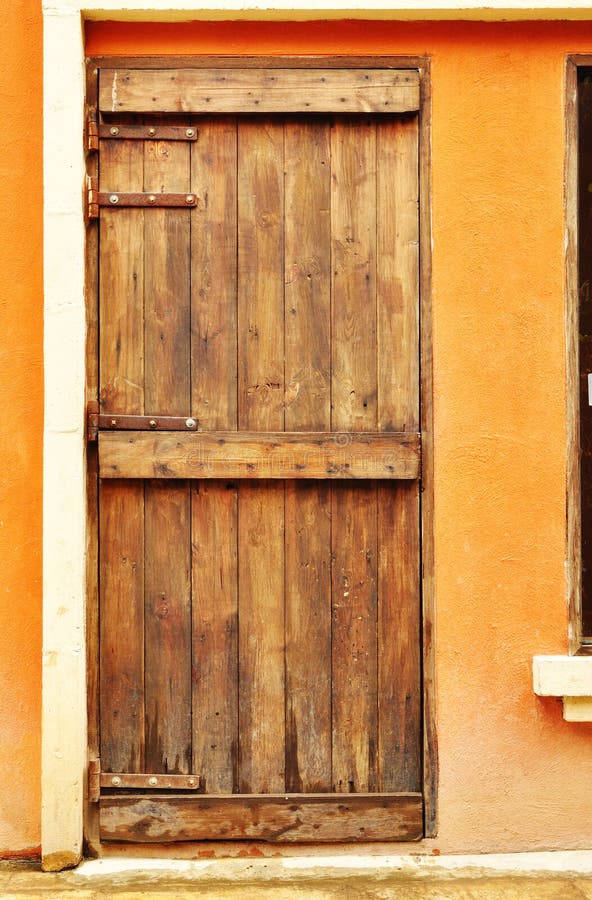 European style wood door on concrete wall