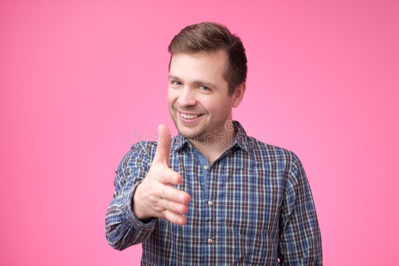 European young man giving hand for handshake stock photo European young man giving hand for handshake stock photo