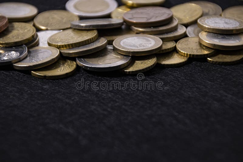 European coins on a black cloth as a frame, close-up, copy space. European coins on a black cloth as a frame, close-up, copy space.