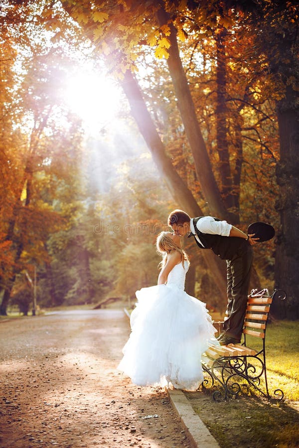 European bride and groom kissing in the park. European bride and groom kissing in the park