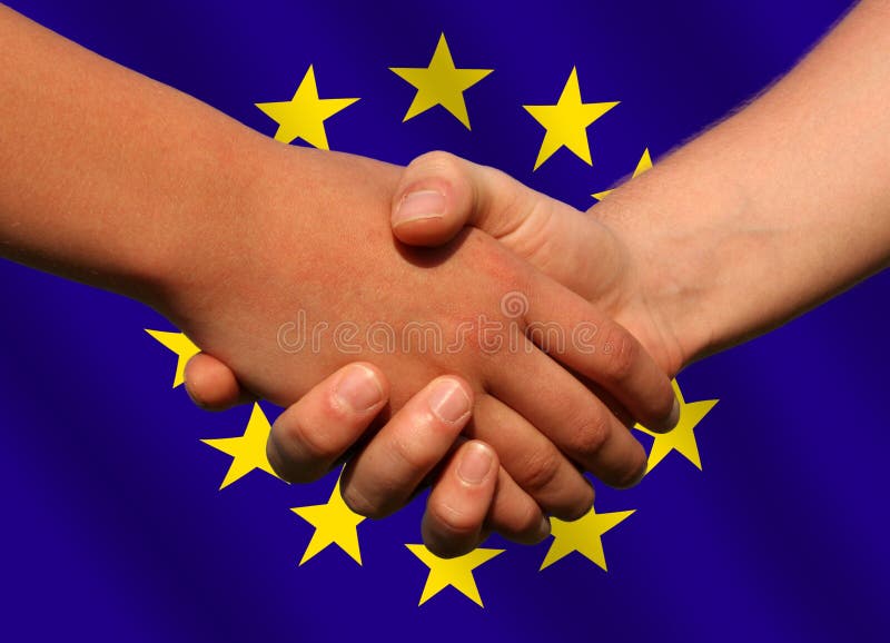 A handshake in front of a waving European Union flag. A handshake in front of a waving European Union flag