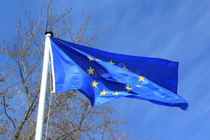 The waving European Union flag on the pole. The waving European Union flag on the pole.