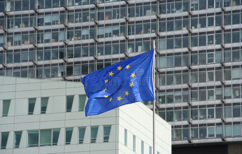 European union flag blowing in wind infront of office buildings. European union flag blowing in wind infront of office buildings