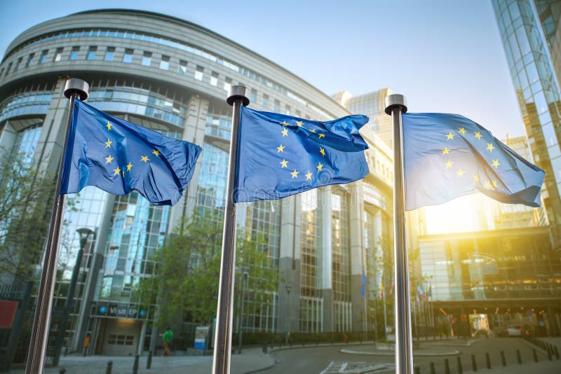 European union flag against parliament in Brussels, Belgium. European union flag against parliament in Brussels, Belgium