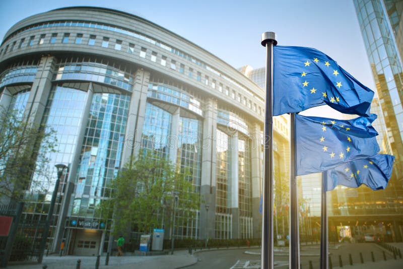 European union flag against parliament in Brussels, Belgium. European union flag against parliament in Brussels, Belgium