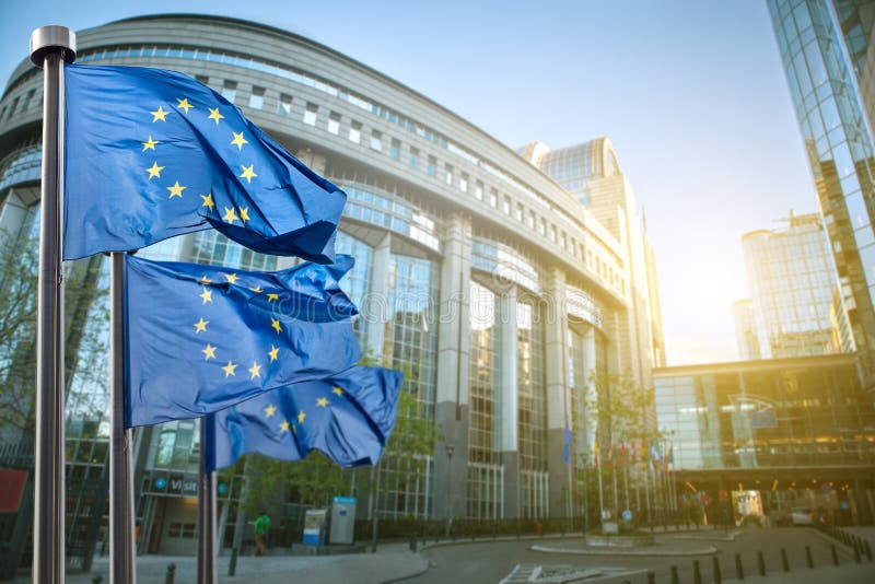 European union flag against parliament in Brussels, Belgium. European union flag against parliament in Brussels, Belgium