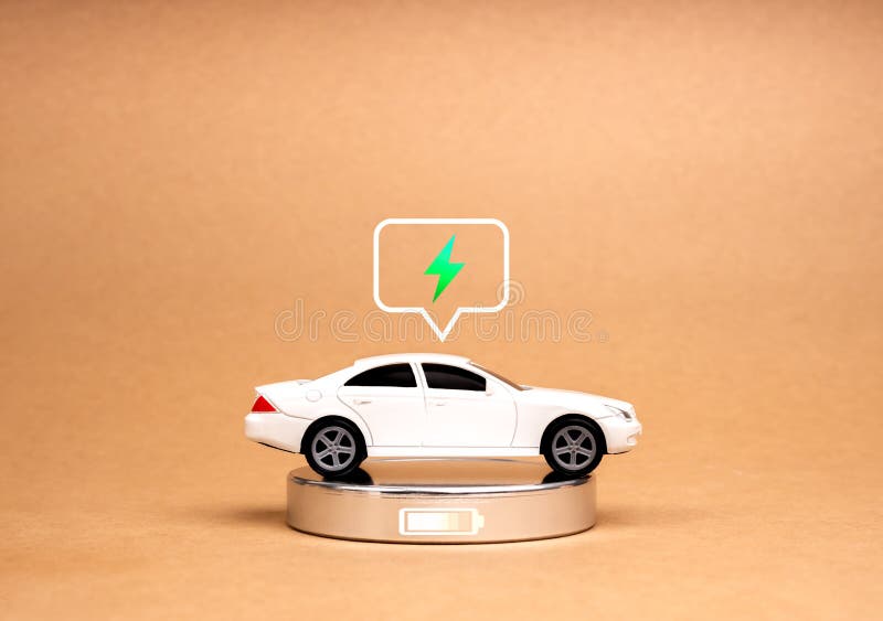 EV car, Electric energy battery charge vehicle with sustainable development concept. A White toy car with electric power icon, recharging full energy on modern chrome charger on eco brown background. Development ev stock images, royalty-free photos and pictures