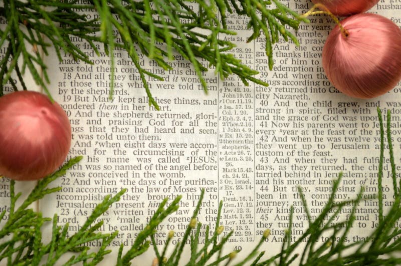 Open Bible, with greenery and ornaments. Bible open to Gospel of Luke, chapter 2, the story of the birth of Christ. Open Bible, with greenery and ornaments. Bible open to Gospel of Luke, chapter 2, the story of the birth of Christ.