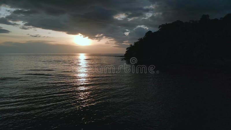 Evening beach spit jungle sunset dark. Fantastic aerial view flight drone