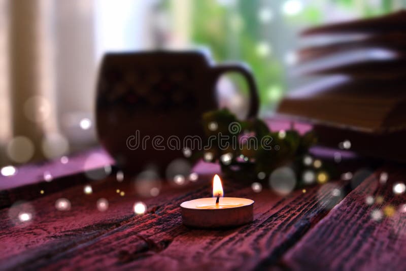 Evening dark twilight burning melting candle. decorative blurred festive bokeh. at home, cozy lazy evening time royalty free stock photos.