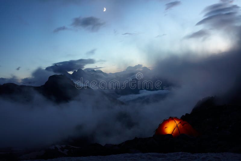 Evening in mountains and moon in the sky