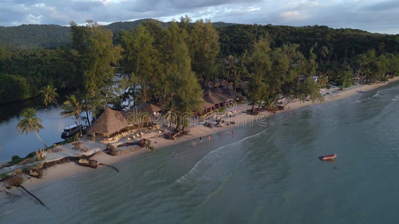 Evening party on the sandbank with restaurant. Perfect aerial view flight drone