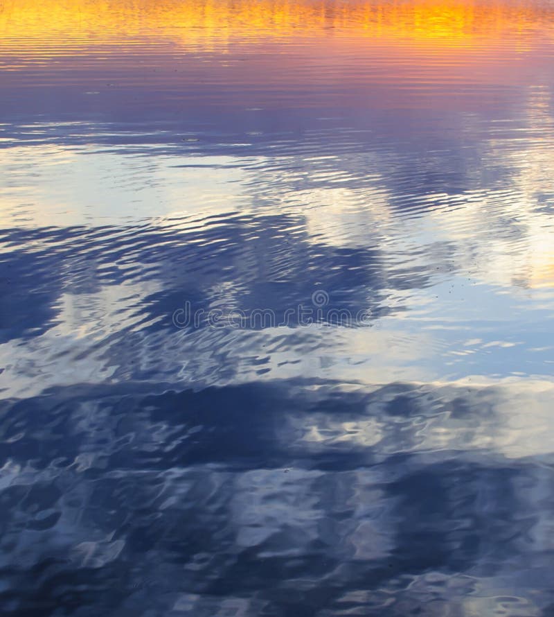 Evening sky colors reflection in lake abstract background