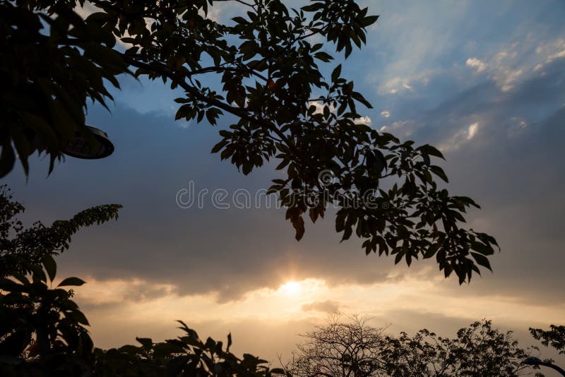 The evening sky is have a beam of light passing through the layers of clouds stock photos