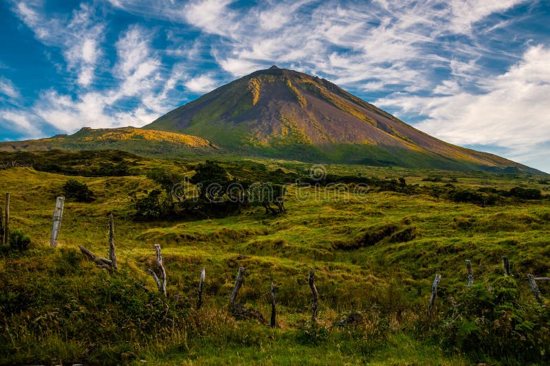 The warm coloured evening sun gracing the volcanic mount Pico on the island of Pico-Azores-Portugal. The warm coloured evening sun gracing the volcanic mount Pico on the island of Pico-Azores-Portugal.