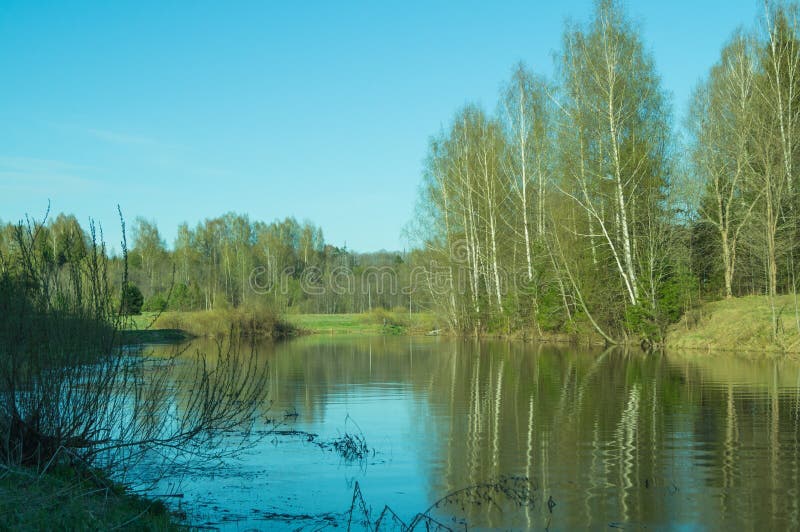 Evening view of Lake with reflection of trees in the water.