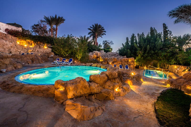 Evening view for luxury swimming pool in night illumination