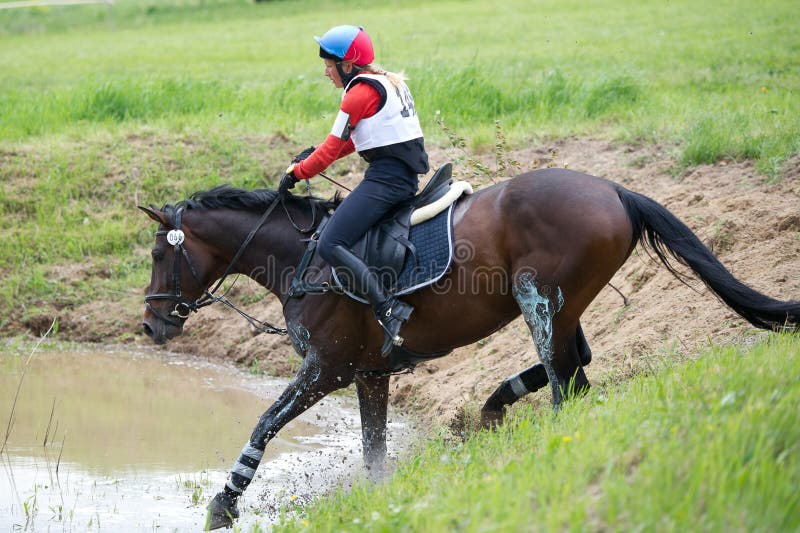 Eventer on Horse is the Water Jump Editorial Stock Photo