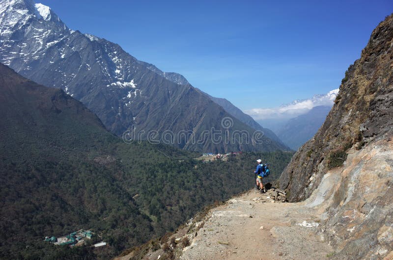 Everest trek, Tourist hiking on Pangboche - Portse upper trail with view of Deboche and Tengboche villages. Mountains Himalayas