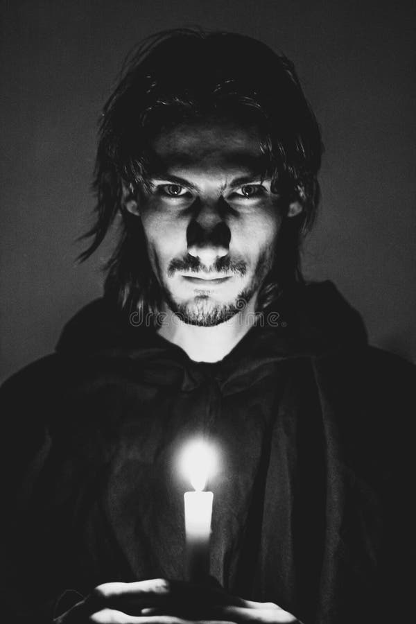 Evil sorcerer with a candle royalty free stock photography