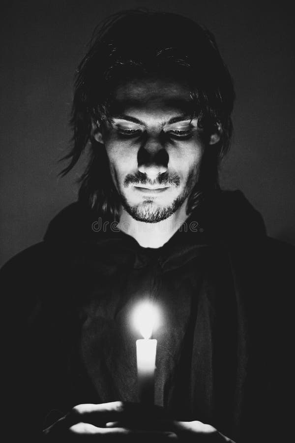 Evil sorcerer with a candle royalty free stock image