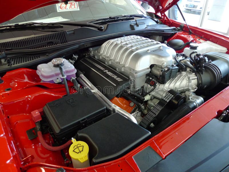 Flashy red Dodge Challenger Hellcat at Blue Ribbon Chrysler Dodge Jeep, Sallisaw, OK. closeup of the Hemi engine and the price tag. Flashy red Dodge Challenger Hellcat at Blue Ribbon Chrysler Dodge Jeep, Sallisaw, OK. closeup of the Hemi engine and the price tag.