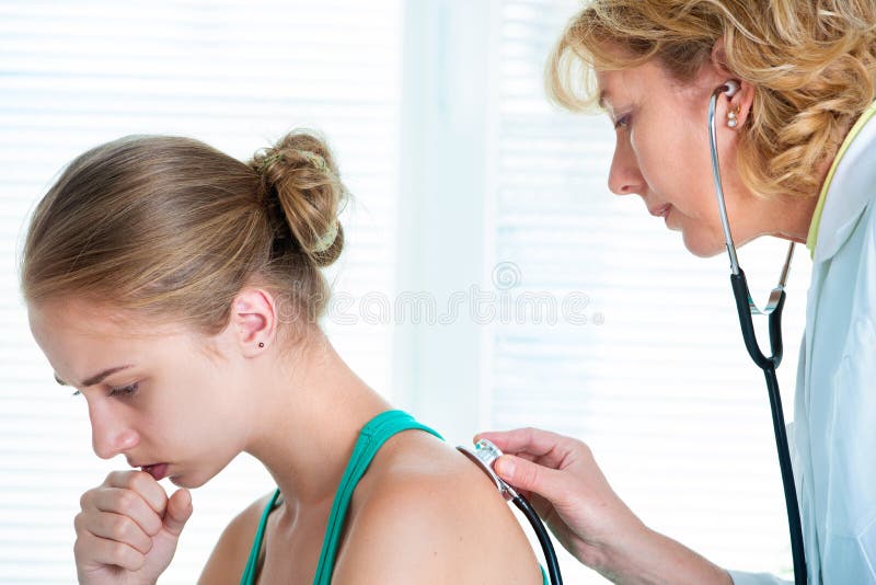 Female doctor examining a teenage girl in her office. Female doctor examining a teenage girl in her office