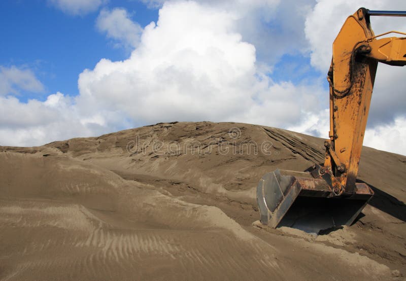 The front of a backhoe Excavator digging in the soil. Claw machine stock images, royalty-free photos and pictures