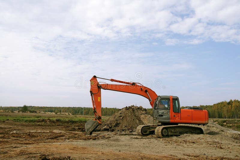 Photo of a working excavator in the countryside. Track hoe construction excavator stock images, royalty-free photos and pictures