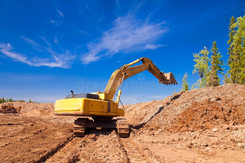 Excavator working on a construction site. Track hoe construction excavator stock images, royalty-free photos and pictures