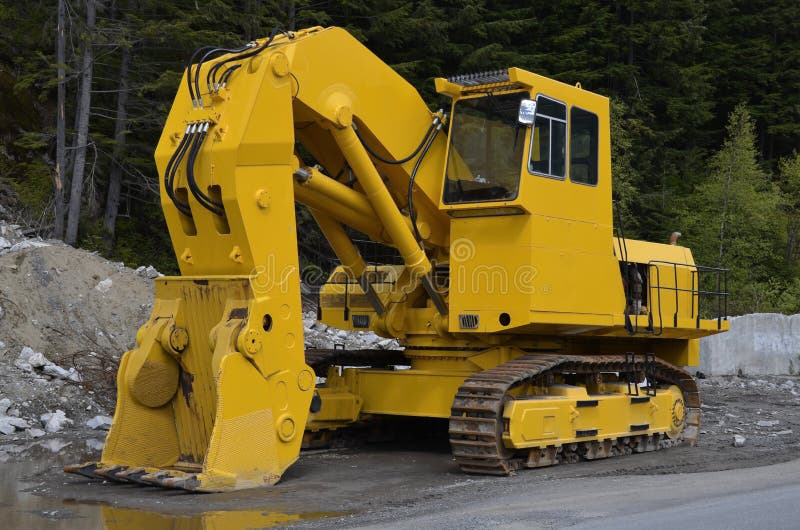 Huge powerful heavy yellow excavator