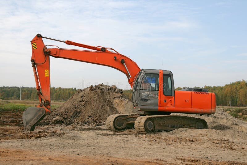 Photo of a working excavator in the countryside. Track hoe construction excavator stock images, royalty-free photos and pictures