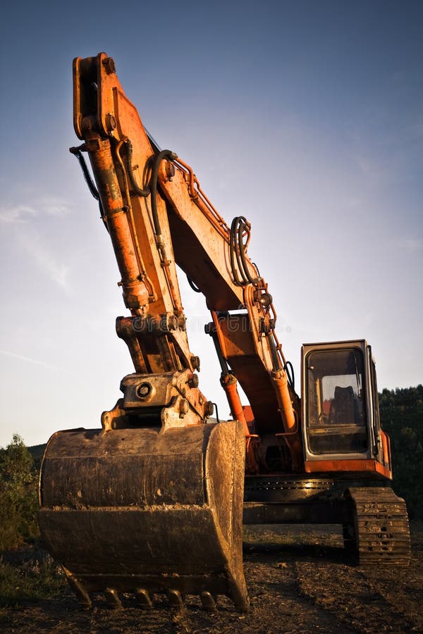 A big orange excavator at construction site. Track hoe construction excavator stock images, royalty-free photos and pictures