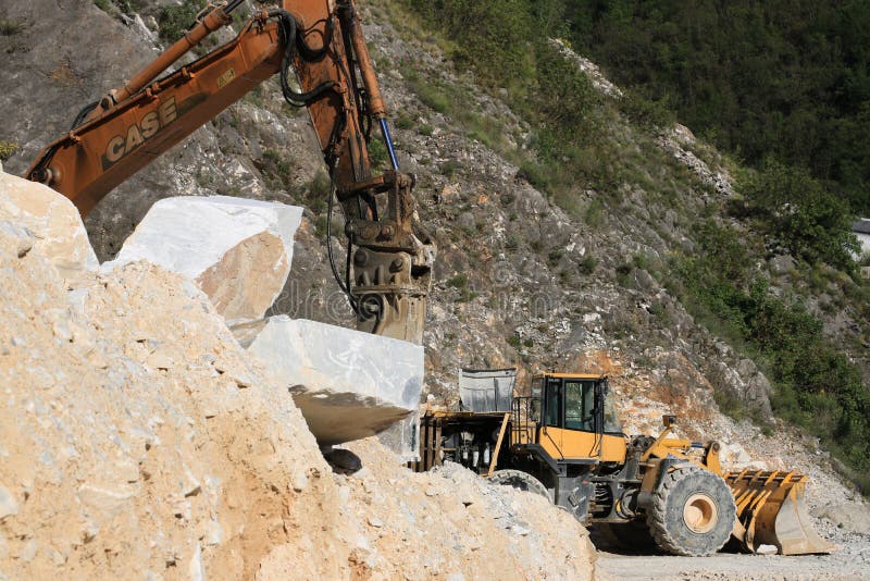 An excavator and a bulldozer in a Carrara marble quarry. A large royalty free stock photos An excavator and a bulldozer in a Carrara marble quarry. A large royalty free stock photos
