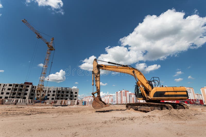 Excavator at a Construction Site Against the Background of a Tower Crane.  Construction, Technology Stock Photo - Image of landscape, industry:  151597142