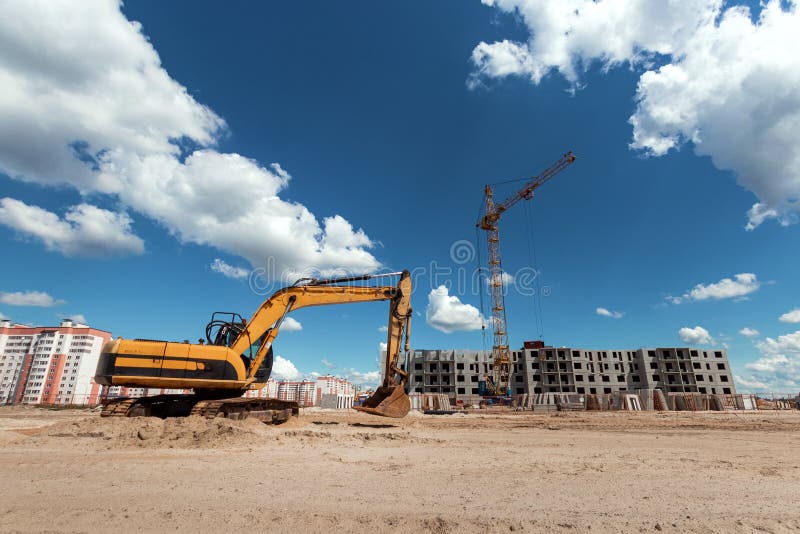 Excavator at a Construction Site Against the Background of a Tower Crane.  Construction, Technology Stock Photo - Image of construction, earth:  151597258