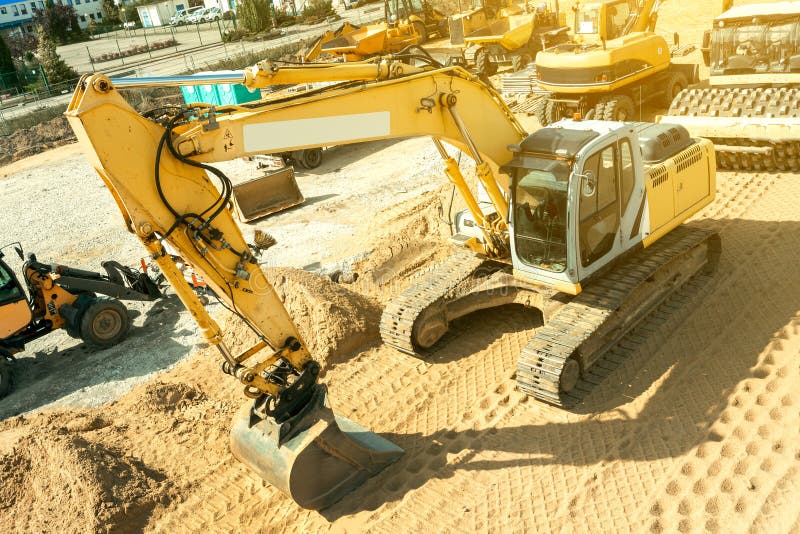 Excavator Plans Land at Construction Site, Excavator Digs Trenches