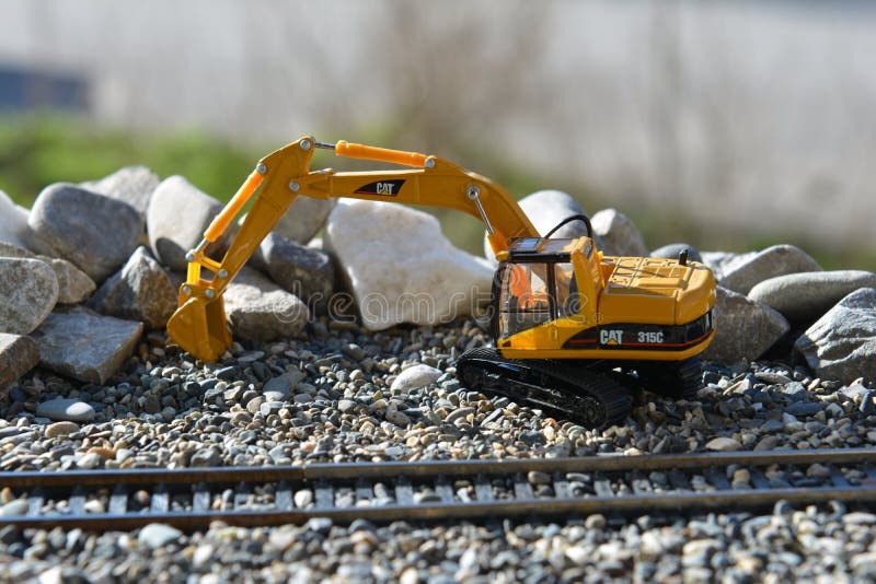 Excavator on the railroad model stock photos Excavator on the railroad model stock photos
