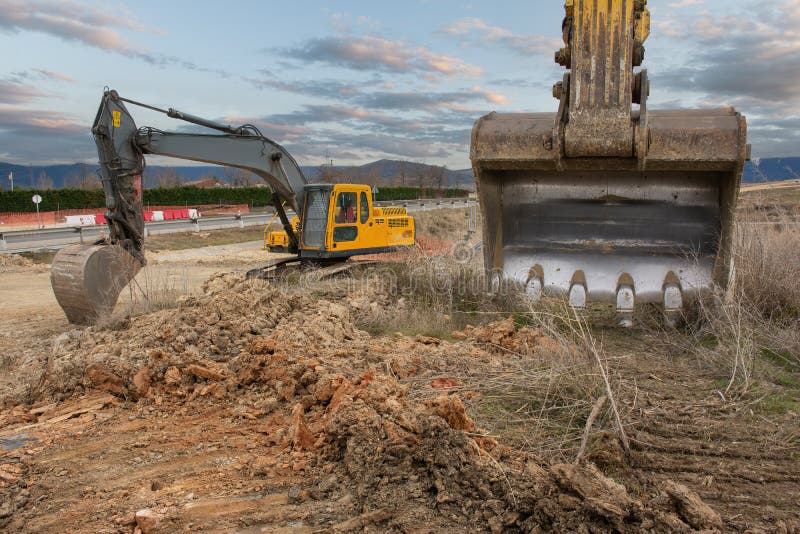 An Excavator at a Road Construction Site Stock Photo Image of soil, stone 257791564