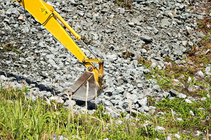 Excavator shovel digging rock royalty free stock photo