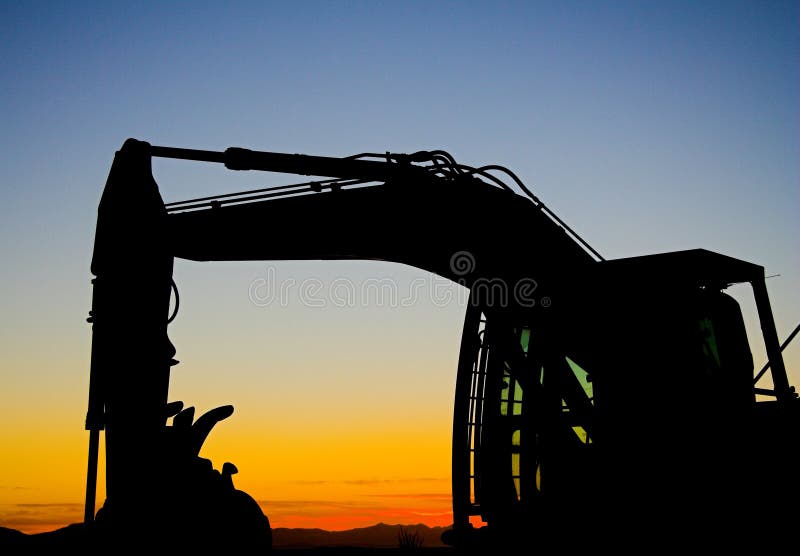 Excavator parked with a sunset background. Track hoe construction excavator stock images, royalty-free photos and pictures