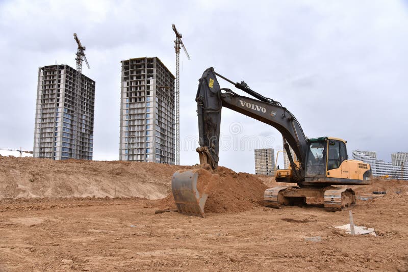 Excavator VOLVO EC240 working at construction site. Earth-moving equipment. Russia, Moscow region, November 11, 2020