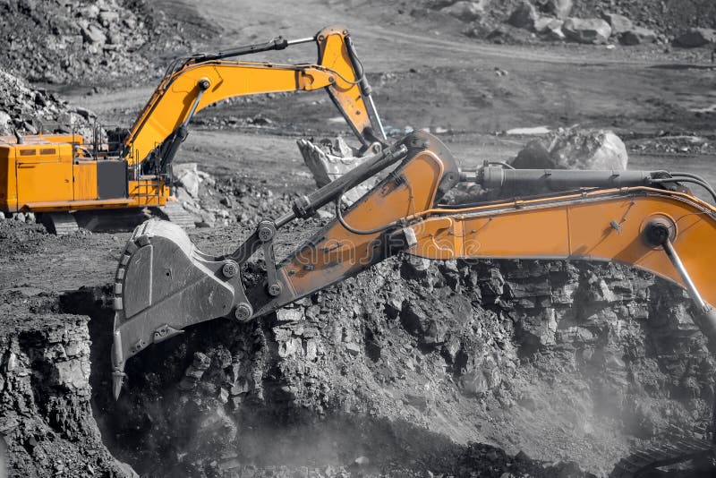 Excavator work loading of coal into Yellow mining truck. Open pit mine industry