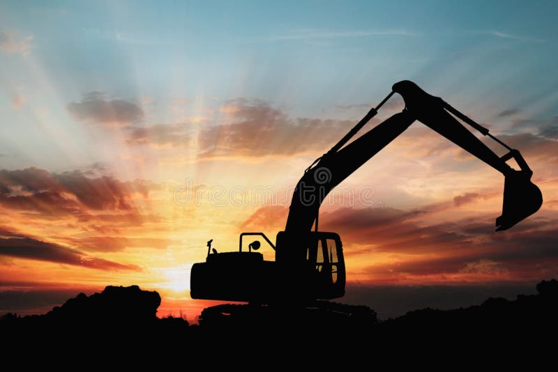 Excavators are digging the soil in the construction site on the sunset background,With image silhouette backhoe. Excavators are digging the soil in the construction site on the sunset background,With image silhouette backhoe